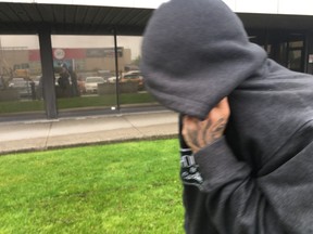 Hit and run suspect Darren Dawson hides his face as he exits court on Tuesday, May 28 2019