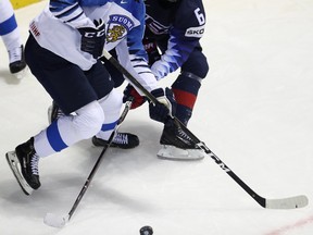 Finland’s Kaapo Kakko (left) and American forward Jack Hughes battle for the puck during the world championship in Slovakia last month. Hughes is expected to go first overall in the NHL draft later this month, but Kakko should give him a run for his money. AP FILES
