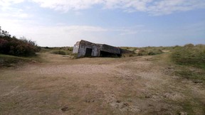 A once-formidable bunker sinks into the sands of Juno Beach. (DAVE POLLARD/Postmedia Network)
