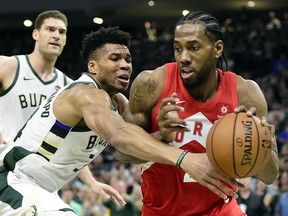 Milwaukee Bucks forward Giannis Antetokounmpo (34) defends as Toronto Raptors forward Kawhi Leonard (2) controls the ball during Game 5 of the NBA Eastern Conference final in Milwaukee on Thursday, May 23, 2019. (THE CANADIAN PRESS/Frank Gunn)