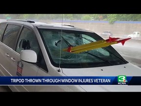 In this video screengrab, a tripod is seen in extruding from the windshield of a van.
