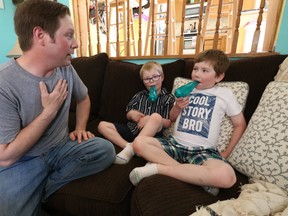 Tottenham's Jamie Larocque gives his sons -- Joshua (blue shirt) and Andre (white shirt) -- their medicine to combat cystic fibrosis in this 2018 Sun file photo. 2018. (Jack Boland/Toronto Sun/Postmedia Network)