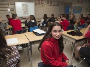 A grade 8 class at Clara Breton Public School wrote letters "home" from the perspective of actual soldiers that died on D-Day. Jasmine Murray (13) selected the soldier pictured, Frank Holmes of Winnipeg. (Derek Ruttan/The London Free Press)