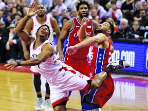 Raps’ Kyle Lowry attempts a reverse layup against Ben Simmons of the Sixers during the first half of Game 7 
last night at Scotiabank Arena. Jack Boland/Toronto Sun