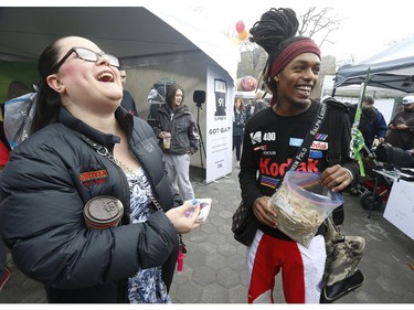 Kandi Burton gets some joints from Sky High (L) at the  Global Marijuana March Toronto took place at the top of Queens Park Circle  - with pop-up vendors and cannabis users - before heading north to Bloor St.W. with about 500 participants   on Saturday May 4, 2019. Jack Boland/Toronto Sun/Postmedia Network