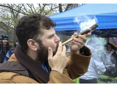 Jonathan Hirsh fires off a 28 gram joint at the Global Marijuana March Toronto took place at the top of Queens Park Circle  - with pop-up vendors and cannabis users - before heading north to Bloor St.W. with about 500 participants   on Saturday May 4, 2019. Jack Boland/Toronto Sun/Postmedia Network
