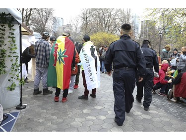 Toronto by-law officers walk through the crowds at the Global Marijuana March Toronto took place at the top of Queens Park Circle  - with pop-up vendors and cannabis users - before heading north to Bloor St.W. with about 500 participants   on Saturday May 4, 2019. Jack Boland/Toronto Sun/Postmedia Network