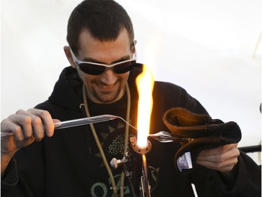 Mastahlaglass makes a glass pipe at the Global Marijuana March Toronto took place at the top of Queens Park Circle  - with pop-up vendors and cannabis users - before heading north to Bloor St.W. with about 500 participants   on Saturday May 4, 2019. Jack Boland/Toronto Sun/Postmedia Network