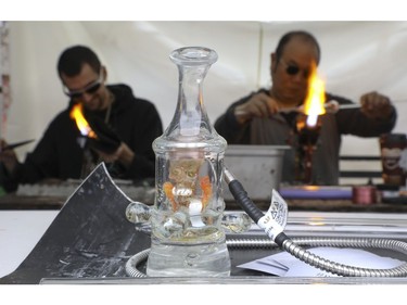 Mastahlaglass (L) makes a glass pipe at the Global Marijuana March Toronto took place at the top of Queens Park Circle  - with pop-up vendors and cannabis users - before heading north to Bloor St.W. with about 500 participants   on Saturday May 4, 2019. Jack Boland/Toronto Sun/Postmedia Network