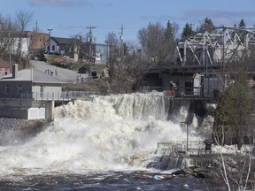 A dam in downtown Bracebridge can't hold back the swollen waters of the Muskoka River on Sunday, April 28, 2019. THE CANADIAN PRESS/Fred Thornhil