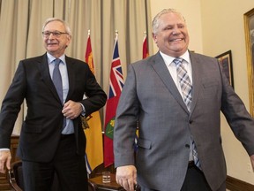 Ontario Premier Doug Ford (right) and New Brunswick Premier Blaine Higgs make their way out of the room after a photo opportunity at the Ontario legislature in Toronto on Wednesday May 22, 2019. THE CANADIAN PRESS/Chris Young