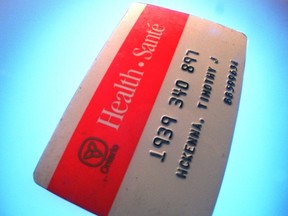 A red-and-white Ontario health card.
