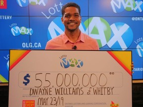 Dwayne Williams, 35, of Whitby, receives his $55-million Lotto Max win at OLG headquarters in Toronto on Thursday, May 23, 2019. OLG photo