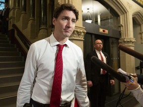 Prime Minister Justin Trudeau stops to talk to reporters as he makes his way to a meeting with his caucus in Ottawa on Wednesday, May 8, 2019. THE CANADIAN PRESS/Fred Chartrand ORG XMIT: FXC101