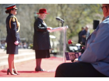 Members of the Fallen Families group sit at the front of the ceremony with roses listening to Lieut.-Governor of Ontario Elizabeth Dowdswell at the 20th annual Ontario Police Memorial Foundation ceremony held at Queens Park honours the 266 officers who have fallen in the line of duty over the years on Sunday May 5, 2019. Jack Boland/Toronto Sun/Postmedia Network