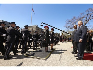 Ontario Provincial Police officers parade past Lieut.-Governor Elizabeth Dowdeswell (red hat), Premier Doug Ford (R) and Ontario Police Memorial Foundation President Mike Adair (beside Ford) at the 20th annual Ontario Police Memorial Foundation ceremony held at Queens Park honours the 266 officers who have fallen in the line of duty over the years on Sunday May 5, 2019. Jack Boland/Toronto Sun/Postmedia Network