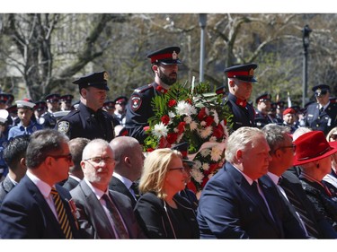 Def. Mike Catlin (L) of the NYPD lays a wreath on behalf of the Police officers of the U.S. at the 20th annual Ontario Police Memorial Foundation ceremony held at Queens Park honours the 266 officers who have fallen in the line of duty over the years on Sunday May 5, 2019. Jack Boland/Toronto Sun/Postmedia Network