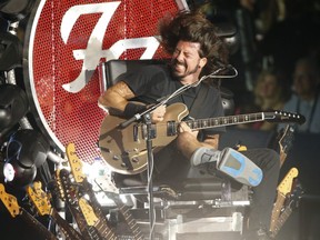 Dave Grohl of the Foo Fighters sports a broken leg as he plays from a guitar throne at the then-Molson Amphitheatre in Toronto on July 8, 2015. Jack Boland/Toronto Sun