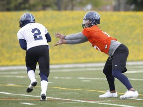 Toronto Argonauts’ James Franklin QB (right) hands off to running back Chris Rainey during training camp this week. (Jack Boland/Toronto Sun)