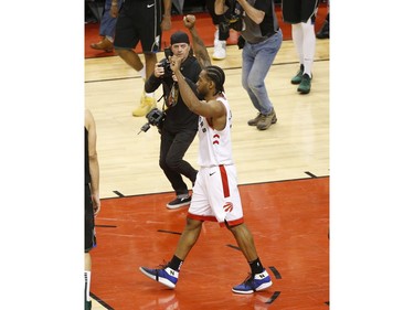 Toronto Raptors Kawhi Leonard SF (2) raises his arms in victory in Toronto, Ont. on Saturday May 25, 2019. Jack Boland/Toronto Sun/Postmedia Network