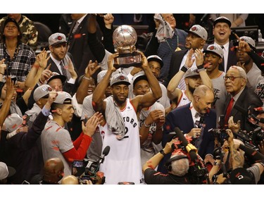 Toronto Raptors Kawhi Leonard SF (2) raises the Eastern Conference champions trophy in Toronto, Ont. on Saturday May 25, 2019. Jack Boland/Toronto Sun/Postmedia Network