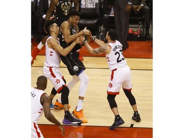 Toronto Raptors Danny Green SG (14). And teammate Fred VanVleet PG (23) try to wrestle the ball from Milwaukee Bucks Giannis Antetokounmpo PF (34) during the first half  in Toronto, Ont. on Saturday May 25, 2019. Jack Boland/Toronto Sun/Postmedia Network