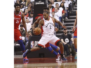 Toronto Raptors Kawhi Leonard SF (2) guarded by Philadelphia 76ers Ben Simmons PG (25) during the first half in Toronto, Ont. on Sunday May 12, 2019.