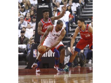 Toronto Raptors Kawhi Leonard SF (2) guarded by Philadelphia 76ers Ben Simmons PG (25) during the first half in Toronto, Ont. on Sunday May 12, 2019.