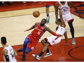 Philadelphia 76ers James Ennis III SF (11) crashes into Toronto Raptors Kawhi Leonard SF (2) during the third quarter in Toronto, Ont. on Sunday, May 12, 2019