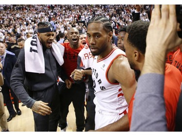 Toronto Raptors Kawhi Leonard SF (2) is congratulated by his teammates after the game in Toronto, Ont. on Sunday, May 12, 2019