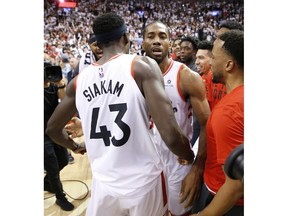 Toronto Raptors Kawhi Leonard SF (2) is congratulated by his teammate Pascal Siakim after the game in Toronto, Ont. on Sunday, May 12, 2019