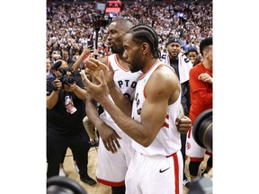 Toronto Raptors Kawhi Leonard SF (2) is congratulated by his teammate Pascal Siakim after the game in Toronto, Ont. on Sunday, May 12, 2019