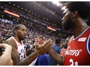 Toronto Raptors Kawhi Leonard SF (2) shakes hands with Philadelphia 76ers Joel Embiid C (21) after the game in Toronto, Ont. on Sunday, May 12, 2019