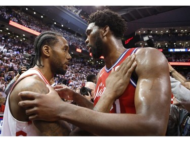 Toronto Raptors Kawhi Leonard SF (2) is hugged by Philadelphia 76ers Joel Embiid C (21) after the game in Toronto, Ont. on Sunday, May 12, 2019. Jack Boland/Toronto Sun/Postmedia Network