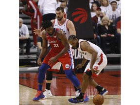 Toronto Raptors Kawhi Leonard SF (2) steals the ball from Philadelphia 76ers Joel Embiid C (21) during the first half in Toronto, Ont. on Sunday May 12, 2019. Jack Boland/Toronto Sun/Postmedia Network