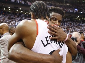 Philadelphia 76ers' Jimmy Butler congratulates Raptors' Kawhi Leonard after the game in Toronto on Sunday. Jack Boland/Toronto Sun