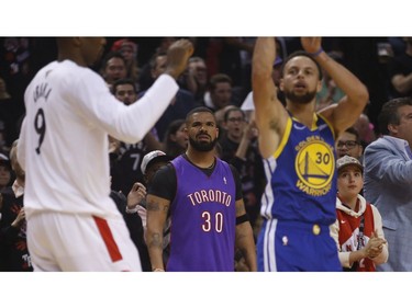 Drake watches a shot by Golden State Warriors Stephen Curry PG (30) during the first half media in Toronto, Ont. on Thursday May 30, 2019. Jack Boland/Toronto Sun/Postmedia Network