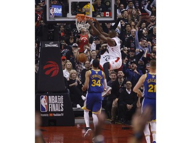 Toronto Raptors Serge Ibaka C (9) slams a ball and hangs on the rim during the first half media in Toronto, Ont. on Thursday May 30, 2019. Jack Boland/Toronto Sun/Postmedia Network