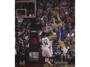 Golden State Warriors Klay Thompson SG (11) flips a ball past the Raptors for two points during the first half media in Toronto, Ont. on Thursday May 30, 2019. Jack Boland/Toronto Sun/Postmedia Network