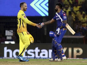 Faf du Plessis of Chennai Super Kings  (left) greets Suryakumar Yadav of Mumbai Indians after Mumbai defeated Chennai to enter the final of the VIVO IPL T20 in Chennai, India, on May 7, 2019. (R. PARTHIBHAN/AP)
