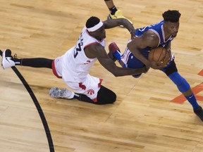 Toronto Raptors forward Pascal Siakam (43) fouls Philadelphia 76ers guard Jimmy Butler (23) during second half, second round NBA basketball playoff action in Toronto, on Monday, April 29, 2019. (THE CANADIAN PRESS/Nathan Denette)