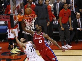 Raptors’ Fred VanVleet (left) doesn’t make the lay up against Philadelphia 76ers Joel Embiid last night at Scotiabank Arena.
 (Jack Boland/Toronto Sun)