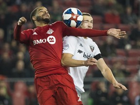 Toronto FC forward Jordan Hamilton, left, eyes the ball against D.C. United midfielder Russell Canouse, right, during second half MLS soccer action in Toronto on Wednesday, May 15, 2019. THE CANADIAN PRESS/Nathan Denette