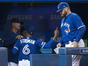 Blue Jays starting pitcher Marcus Stroman argues with Jays pitching coach Pete Walker (left) after being pulled from Saturday's game against the Chicago White Sox during seventh inning NATHAN DENETTE/THE CANADIAN PRESS)