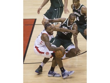 Kawhi Leonard & Khris Middleton collide in the 4th quarter action in Game 3 of the Eastern Conference Finals as the Toronto Raptors go on to beat the Milwaukee Bucks,  in Toronto, Ont. on Monday May 20, 2019. Stan Behal/Toronto Sun/Postmedia Network