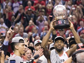 Kawhi Leonard holds up the Eastern Conference Championship trophee after The Raptors beat the Milwaukee Bucks on Saturday May 25, 2019.