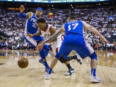Toronto Raptors Kyle Lowry during playoff action against Philadelphia 76ers Tobias Harris (left) and JJ Redick at the Scotiabank Arena  in Toronto, Ont. on Tuesday May 7, 2019. Ernest Doroszuk/Toronto Sun/Postmedia