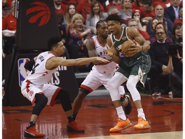 Toronto Raptors Danny Green SG (14) and teammate Kawhi Leonard guard Milwaukee Bucks Giannis Antetokounmpo PF (34) during the first half in Toronto, Ont. on Tuesday May 21, 2019. Jack Boland/Toronto Sun/Postmedia Network