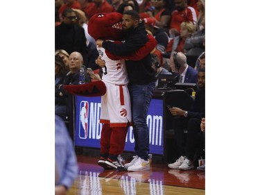 The Raptor hugs Drake during the first half in Toronto, Ont. on Tuesday May 21, 2019. Jack Boland/Toronto Sun/Postmedia Network