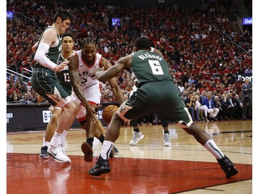 Toronto Raptors Kawhi Leonard SF (2) is triple teamed by Milwaukee Bucks Eric Bledsoe PG (6) during the second half in Toronto, Ont. on Tuesday May 21, 2019. Jack Boland/Toronto Sun/Postmedia Network